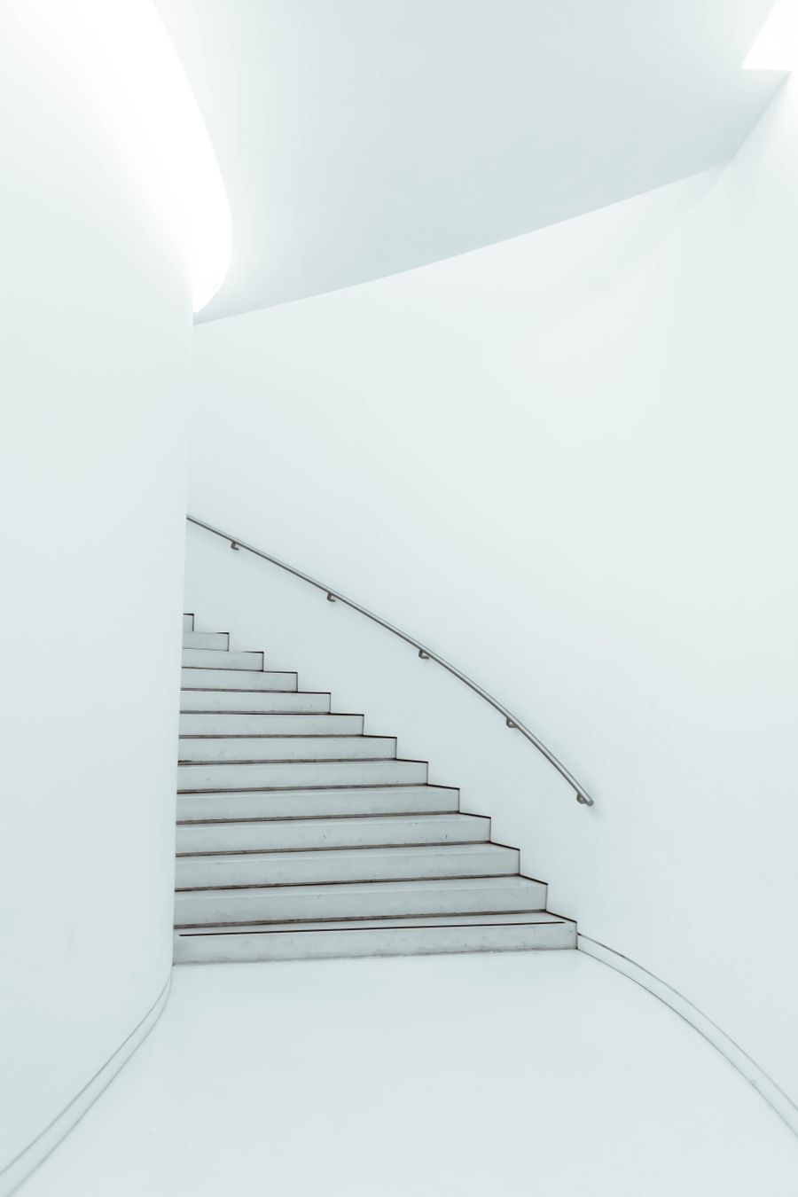 Escalera blanca que conecta los dos pisos de la clínica